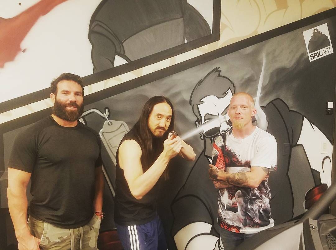 Shae Petersen with Dan Bilzerian and Steve Aoki in front of a SRIL ART mural