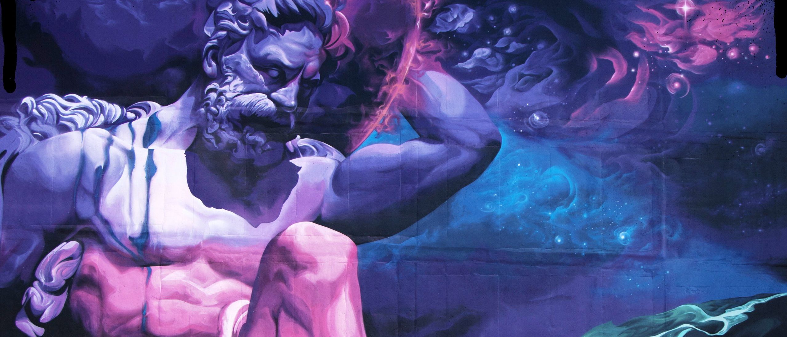 Monumental Neptune painted in violet and pink aerosol across a block wall, arm raised against a deep blue cosmos