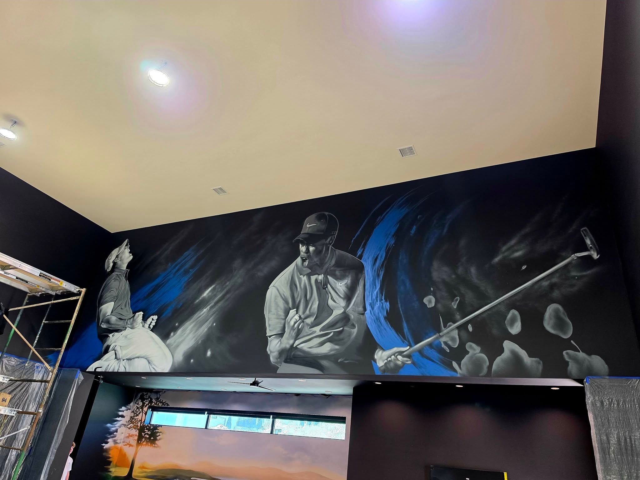 Grayscale portrait of a golfer mid-swing painted across a charcoal wall above a home golf simulator