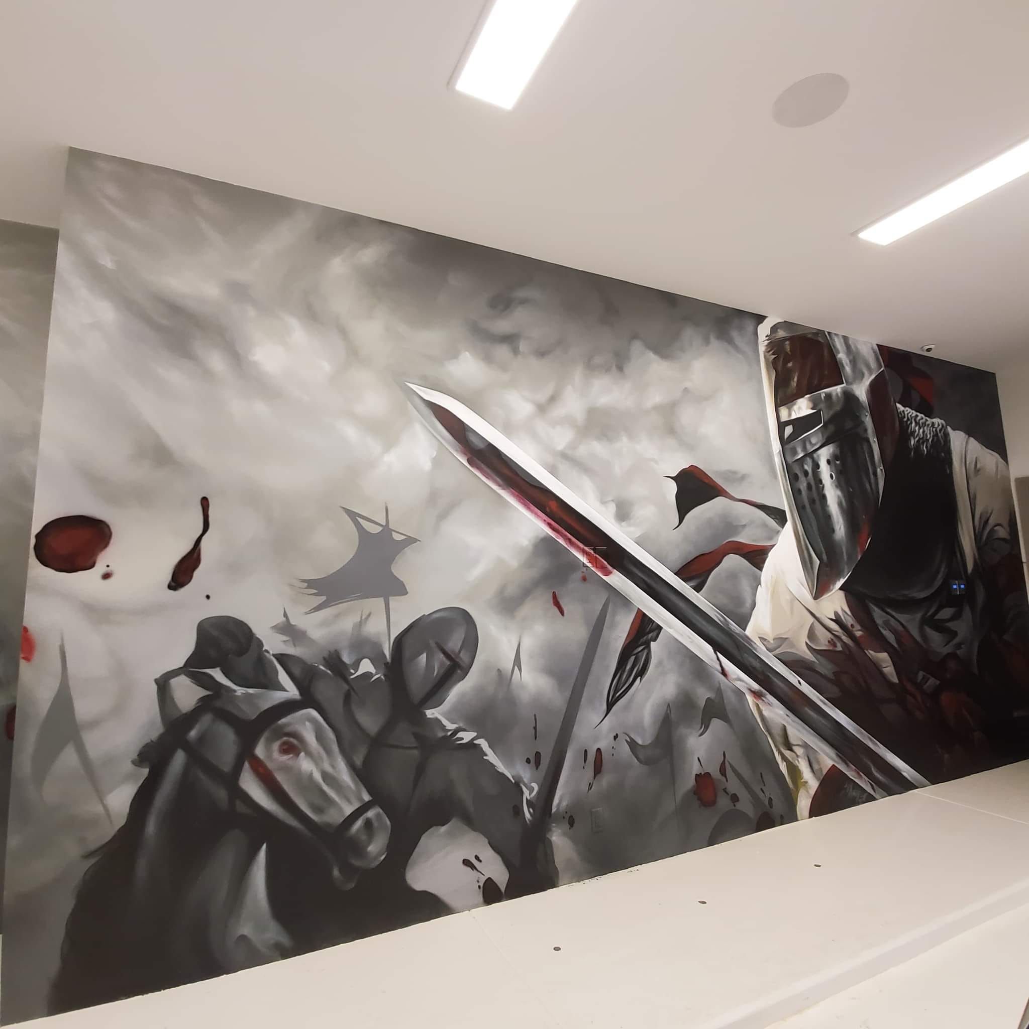 Shae Petersen (SRIL ART) painting custom medieval knight battle mural for Post Malone