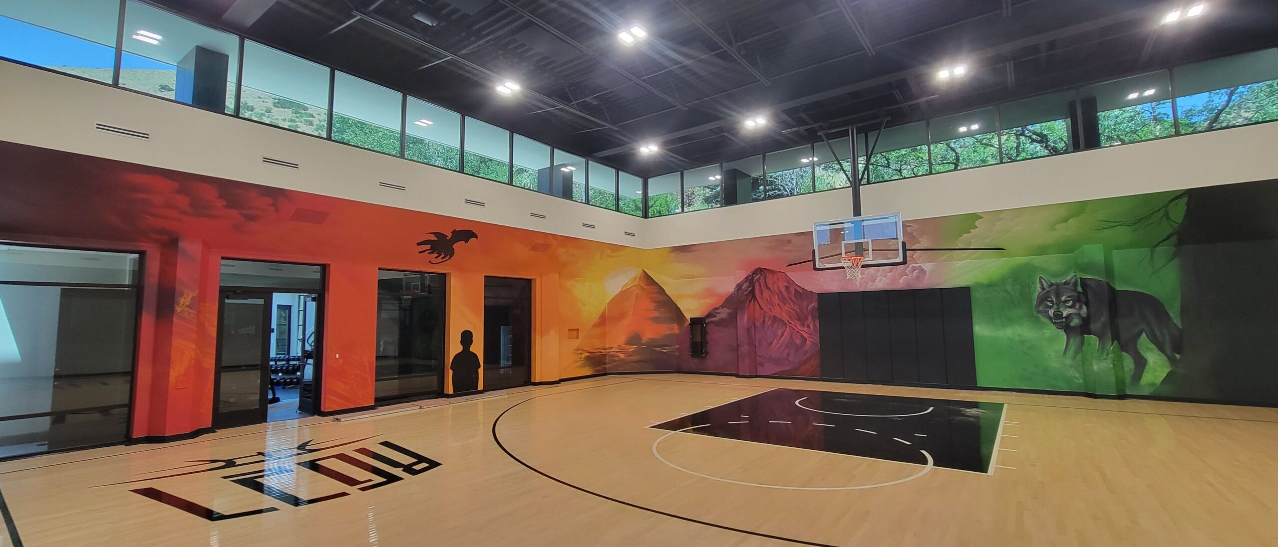 Shae Petersen (SRIL ART) painting custom narrative mural for Rudy Gobert's private court