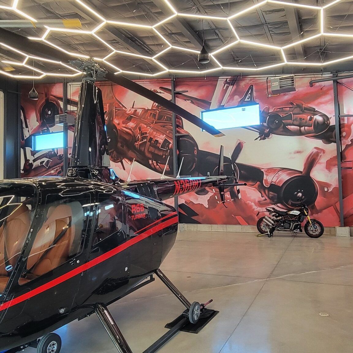 Vintage warplanes in red and white spray paint covering an interior aircraft hangar wall