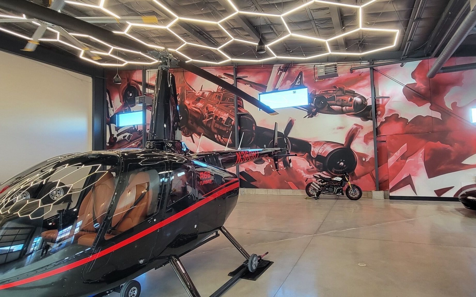 Vintage warplanes in red and white spray paint covering an interior aircraft hangar wall