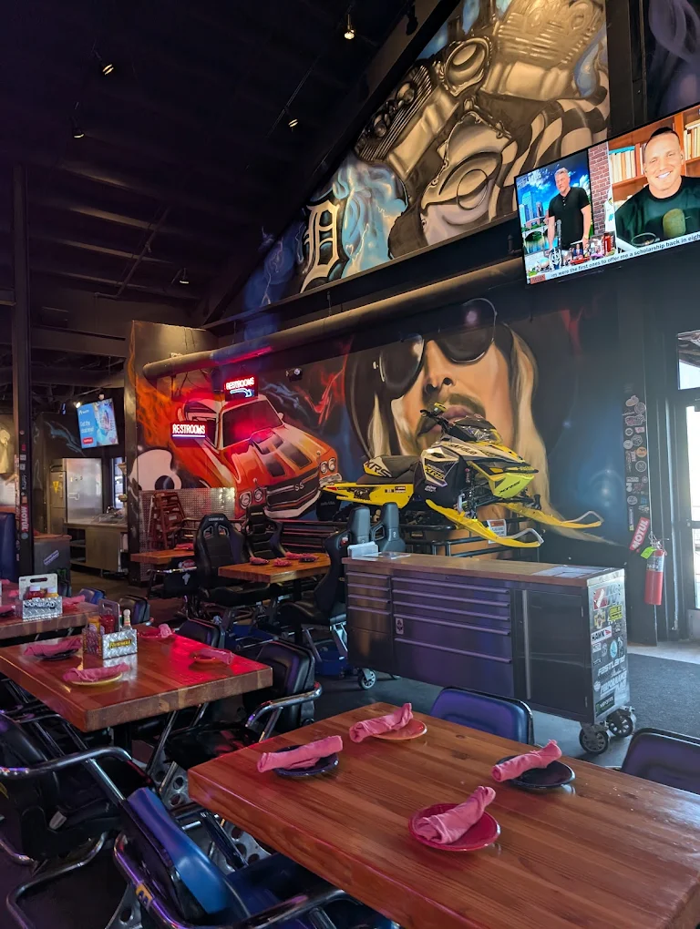 Kid Rock portrait mural with hot rod and snowmobile graphics inside a Park City restaurant