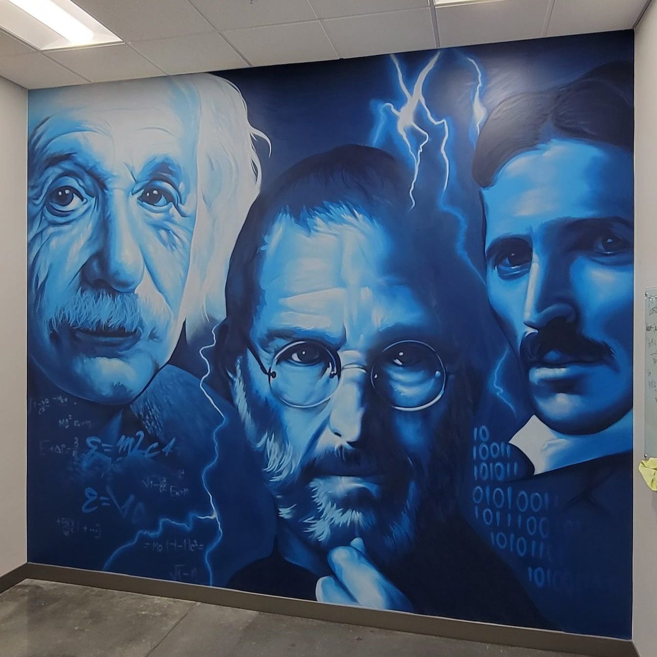 Einstein, Steve Jobs and Nikola Tesla portrait mural in blue tones on an interior office wall