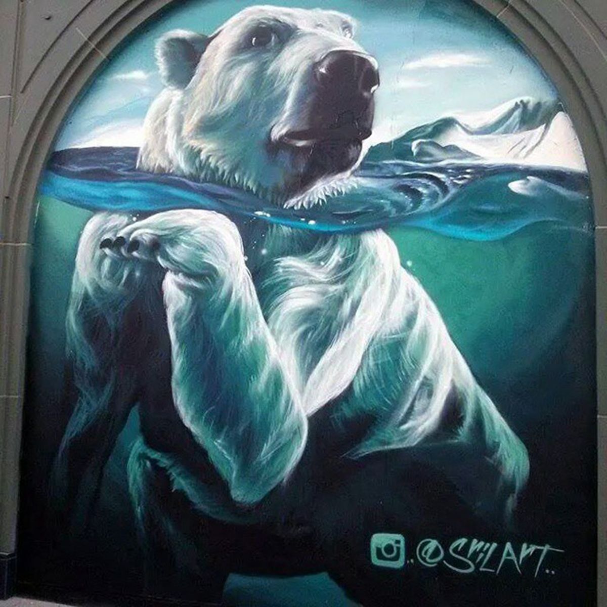 Polar bear swimming mural painted inside an arched stone alcove at The Linq in Las Vegas