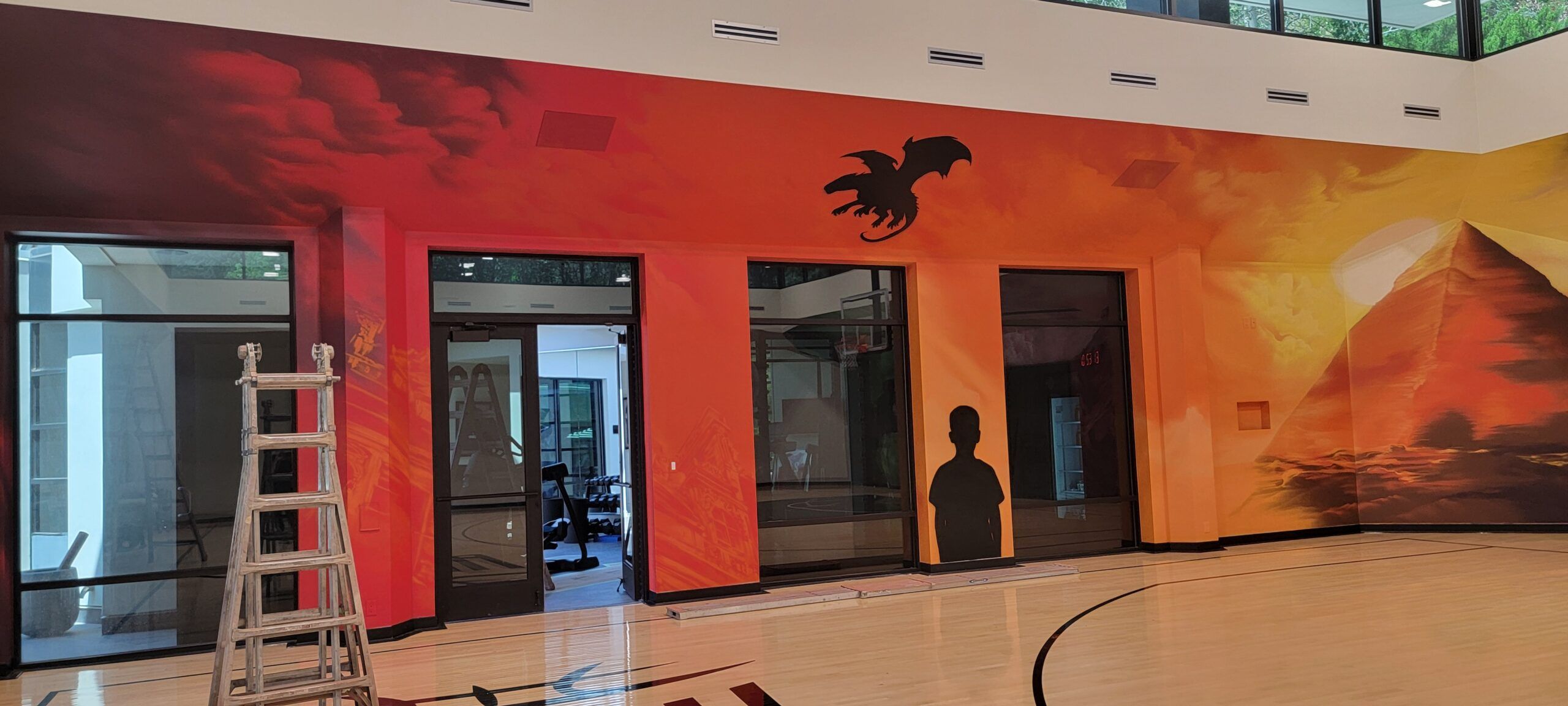 100ft long custom hand-painted mural featuring pyramids and surrealist landscapes for Rudy Gobert