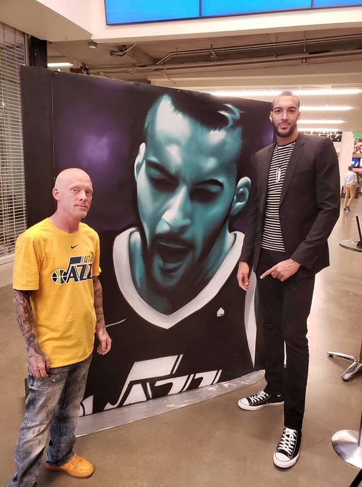 Shae Petersen with Utah Jazz center Rudy Gobert beside SRIL ART's mural portrait of him