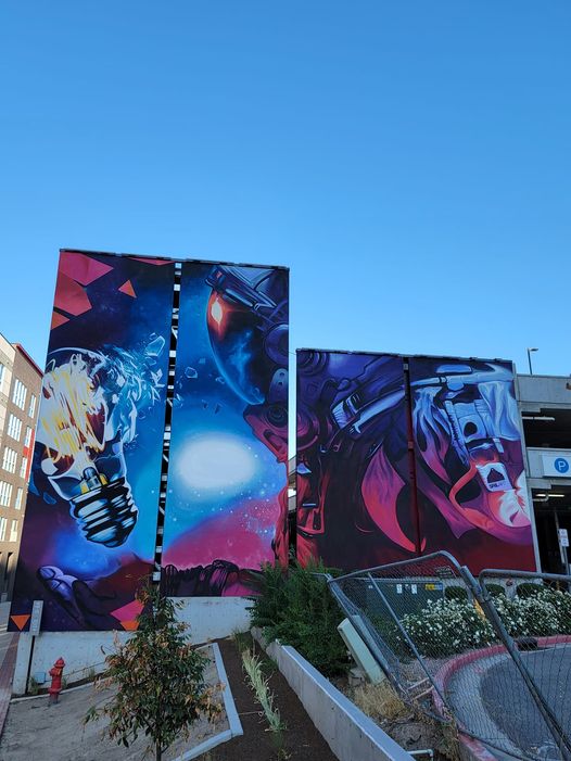SRIL ART painting massive astronaut mural at Paperbox Lofts Salt Lake City