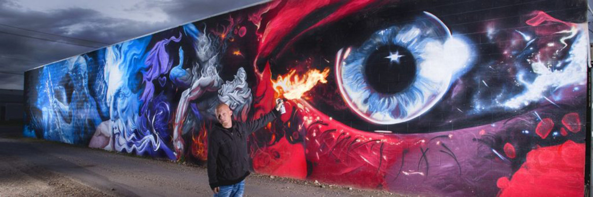 Shae Petersen SRIL ART painting the 100ft Godlike mural in Salt Lake City